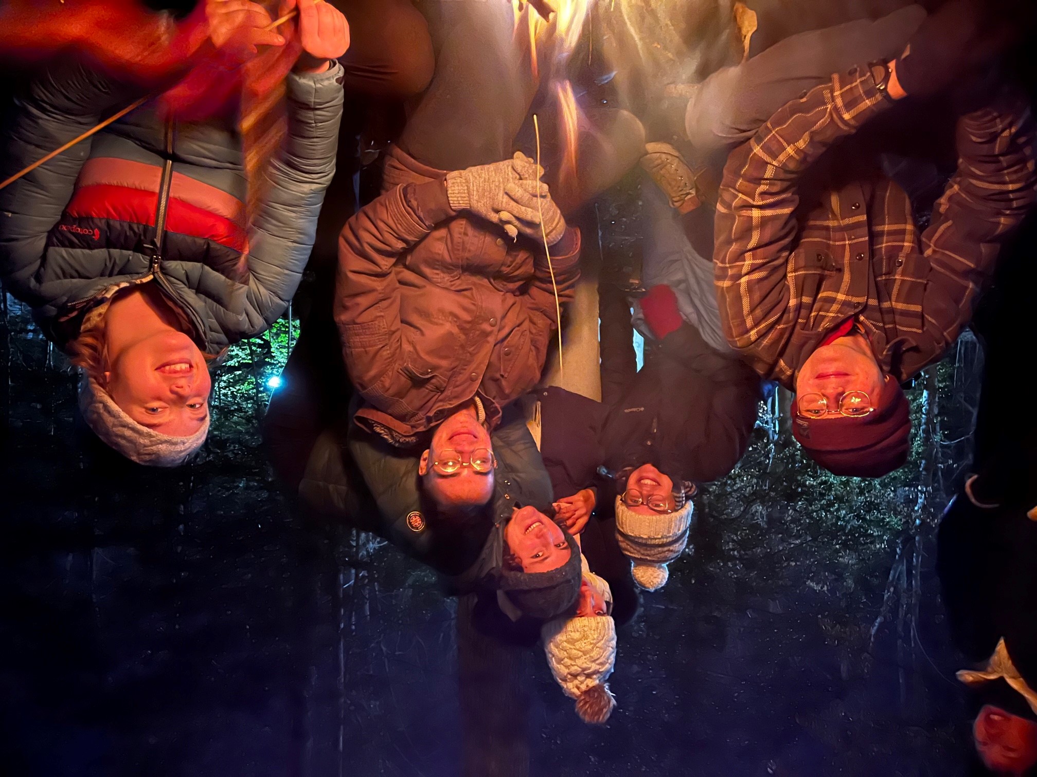 students around campfire at night