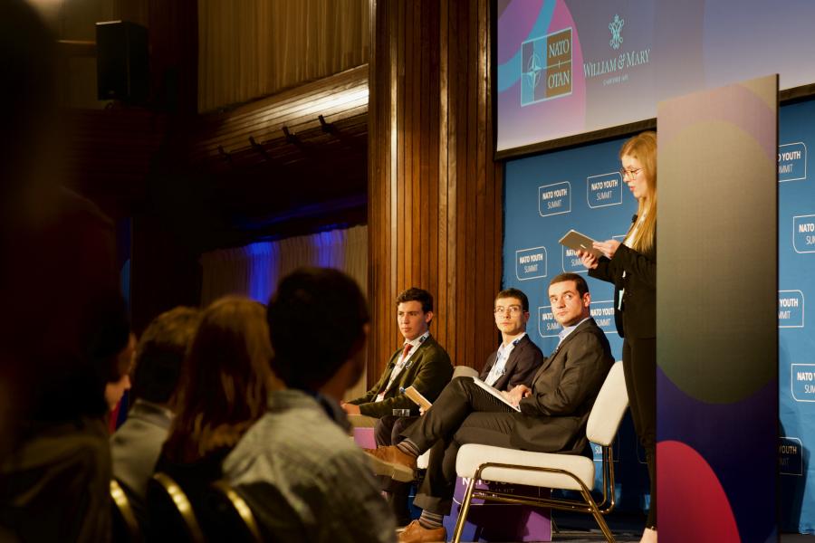 Guests speaking on stage at the NATO Youth Summit 2022.